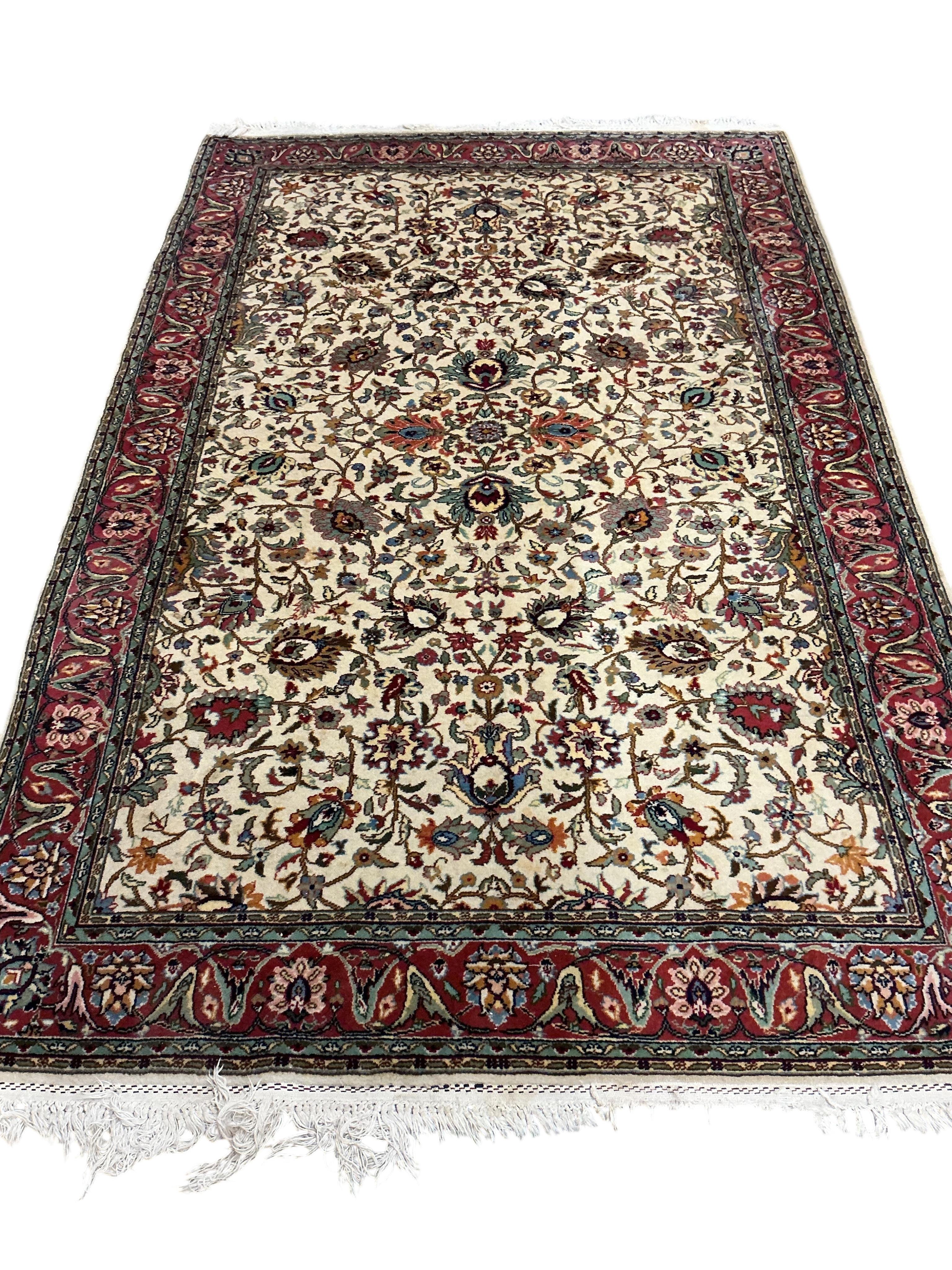 A Tabriz ivory ground carpet, 230 x 146cm